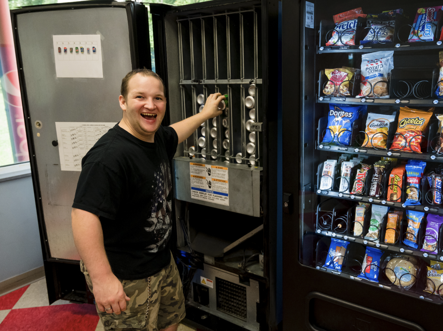 A gentleman stocking a vending machine